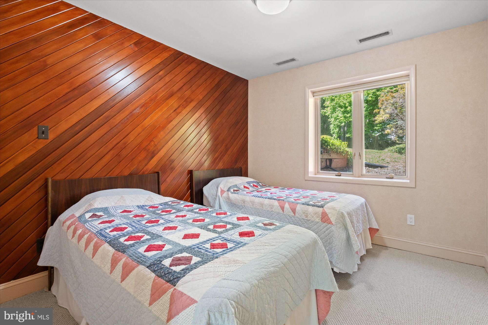 7211 Brickyard Road Potomac, MD 20854 - Photo 32 of 46 a bedroom with two beds and a lamp on dresser