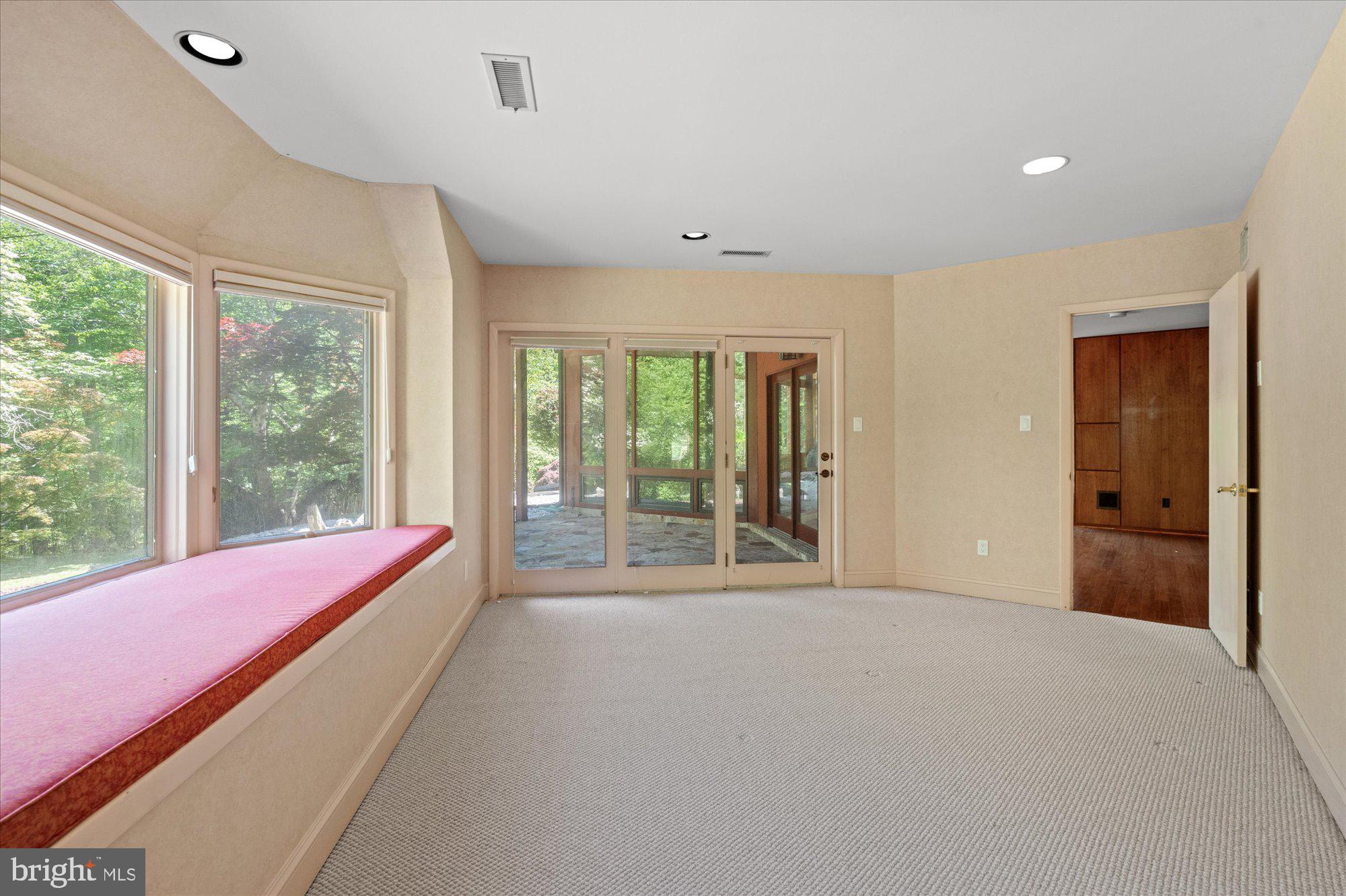 7211 Brickyard Road Potomac, MD 20854 - Photo 34 of 46 a large bedroom with a bed and glass door