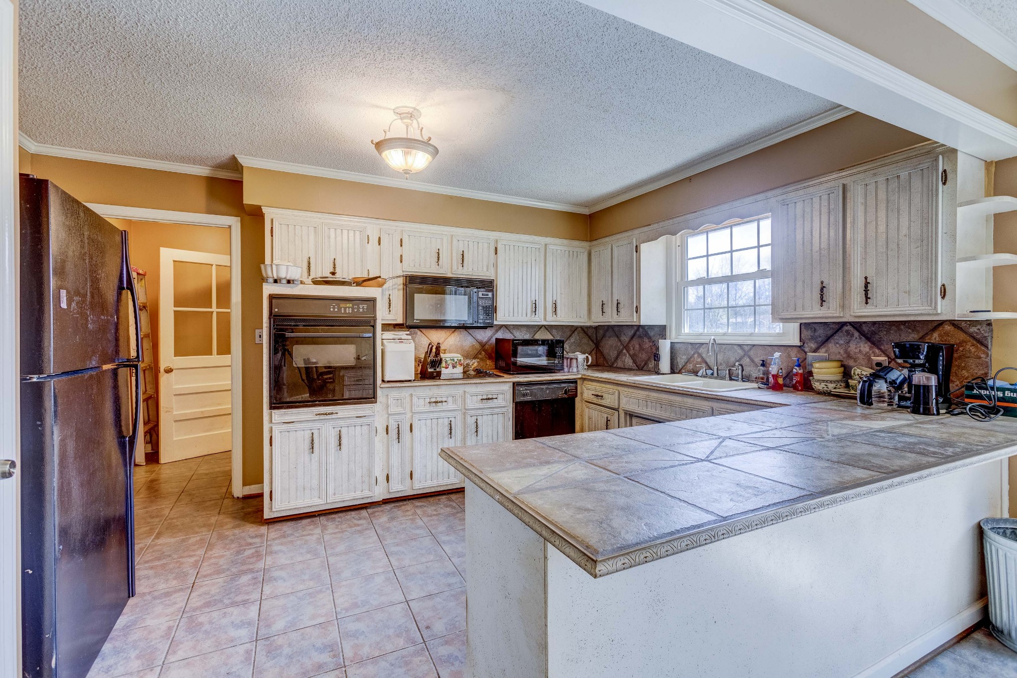 223 Lohman Road Mount Juliet, TN 37122 - Photo 14 of 15 a kitchen with stainless steel appliances granite countertop a refrigerator a sink a stove and white cabinets