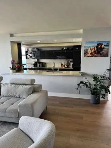 a living room with furniture and potted plant