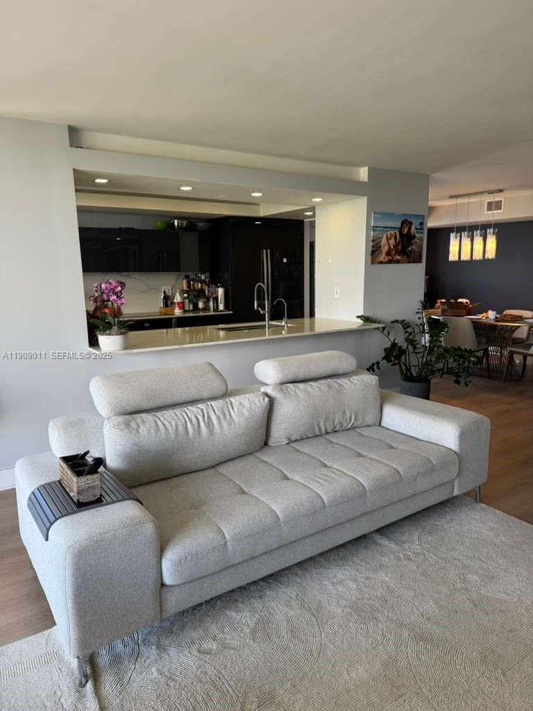 4000 Towerside Terrace, Unit 1901 Miami, FL 33138 - Photo 12 of 36 a living room with furniture and a fireplace