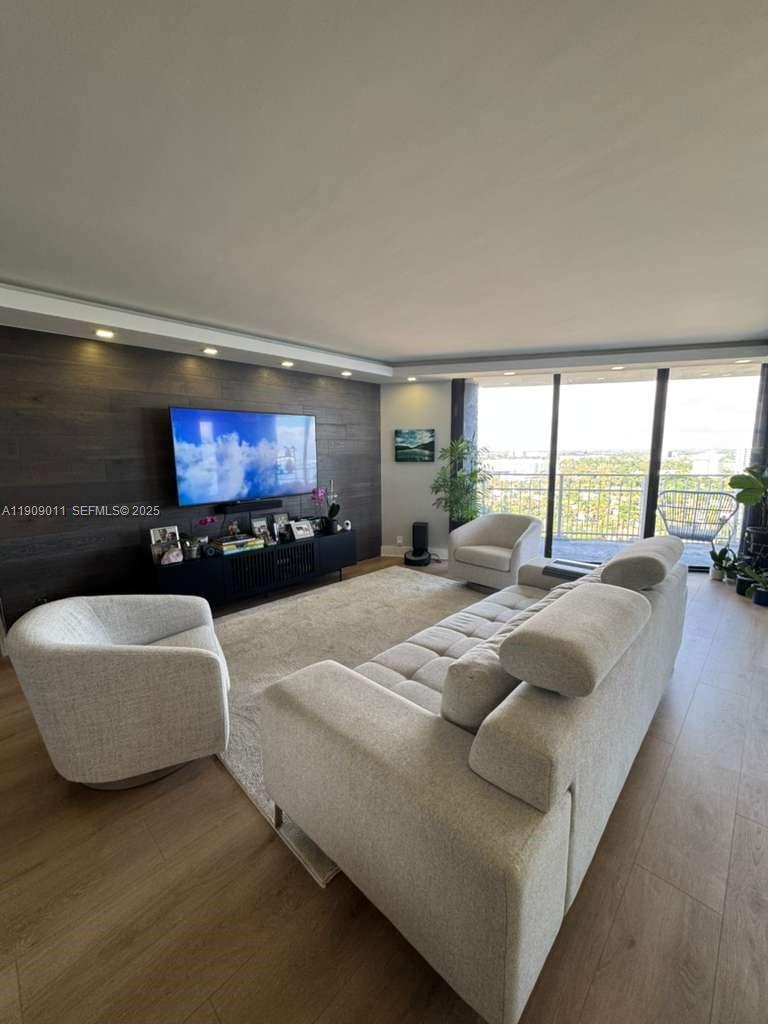 4000 Towerside Terrace, Unit 1901 Miami, FL 33138 - Photo 13 of 36 a living room with furniture and a flat screen tv