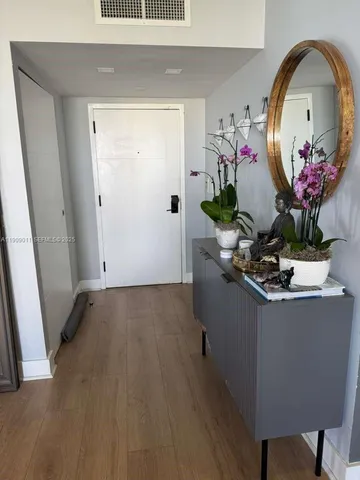 a living room with furniture and flowers