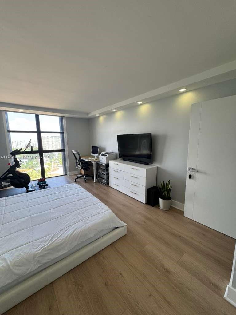 4000 Towerside Terrace, Unit 1901 Miami, FL 33138 - Photo 23 of 36 a living room with furniture and a flat screen tv