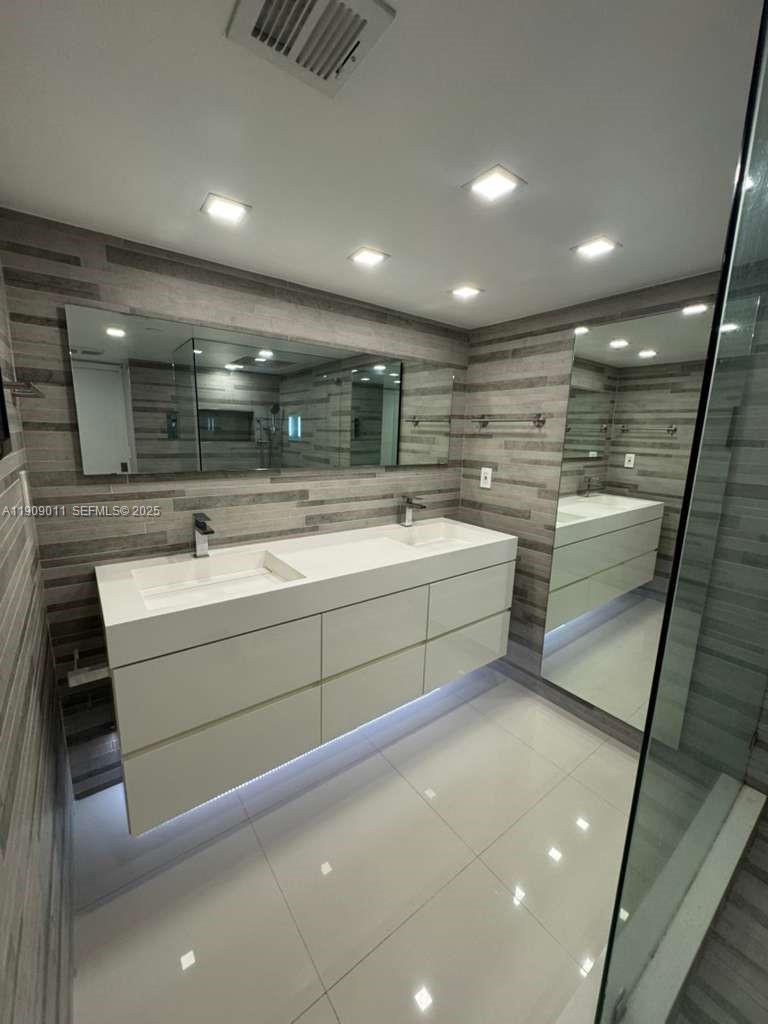 4000 Towerside Terrace, Unit 1901 Miami, FL 33138 - Photo 24 of 36 a bathroom with a sink and a mirror