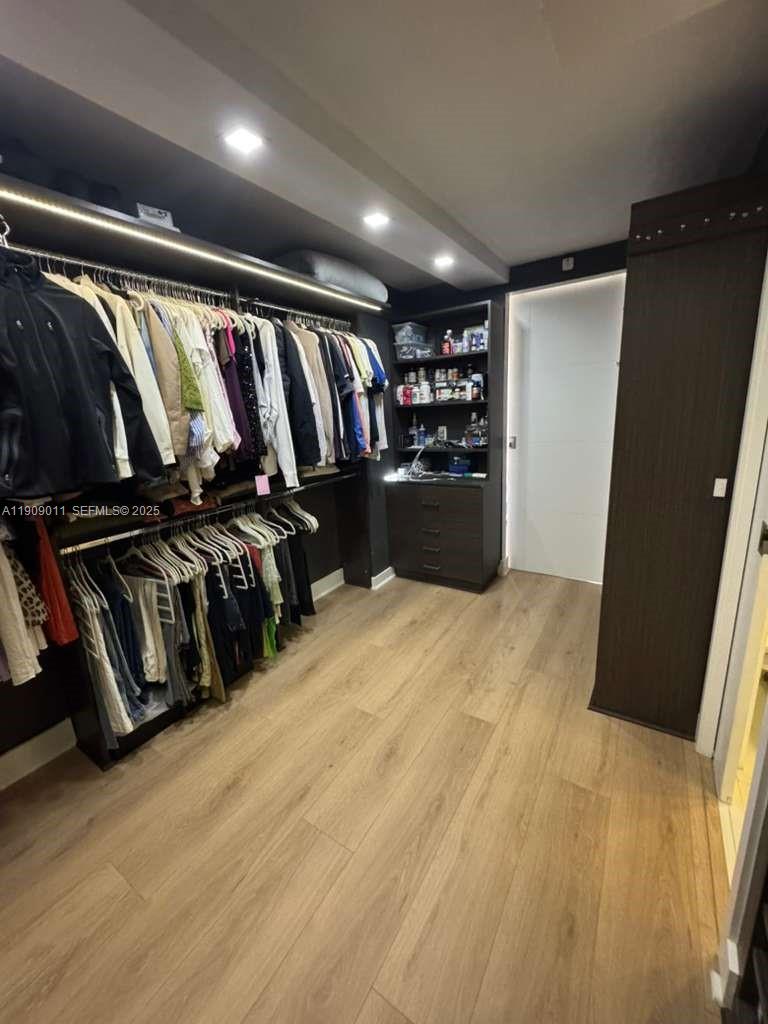 4000 Towerside Terrace, Unit 1901 Miami, FL 33138 - Photo 29 of 36 a view of walk in closet with clothes and shoes