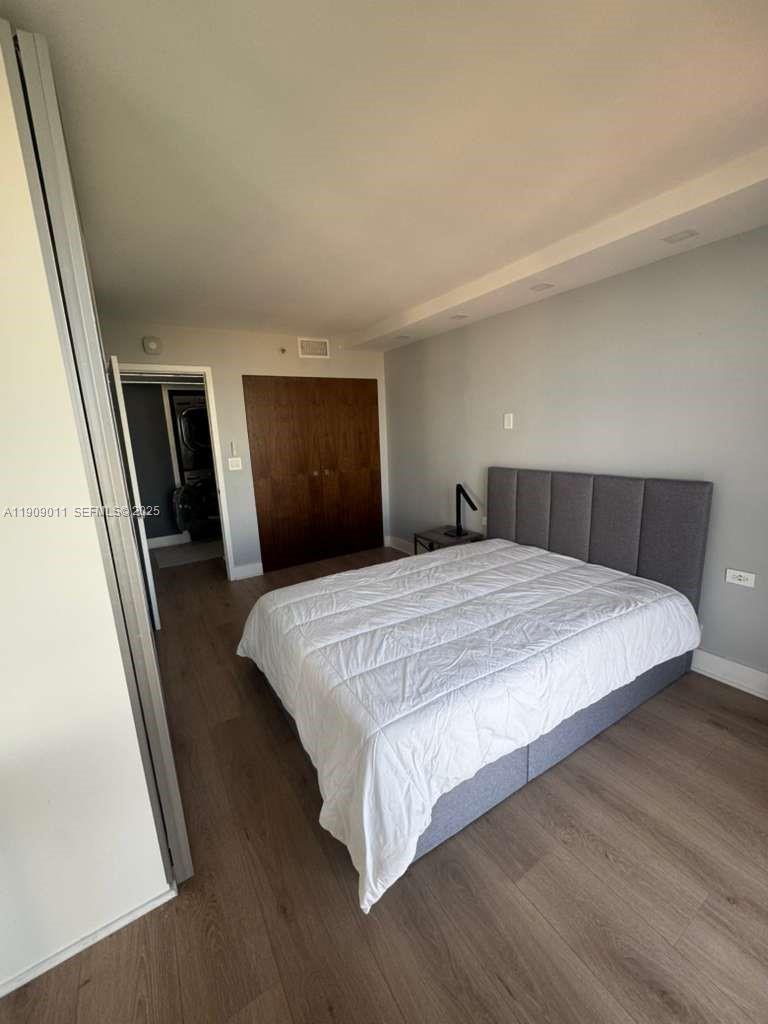 4000 Towerside Terrace, Unit 1901 Miami, FL 33138 - Photo 32 of 36 a bedroom with a bed and mirror