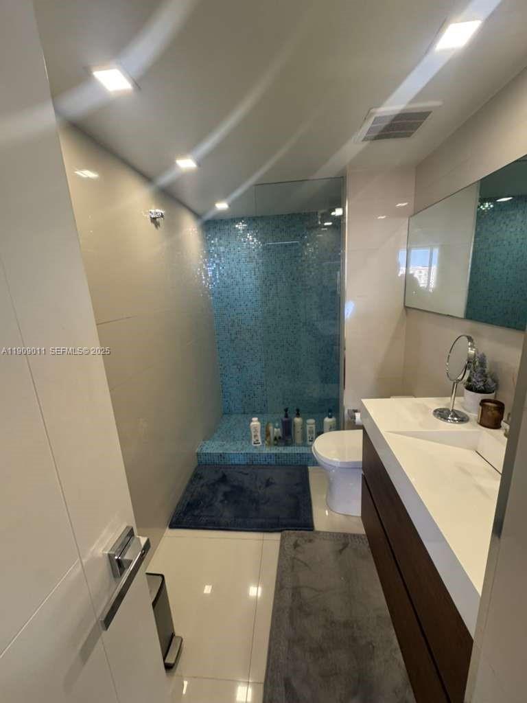 4000 Towerside Terrace, Unit 1901 Miami, FL 33138 - Photo 36 of 36 a bathroom with a sink a toilet and shower
