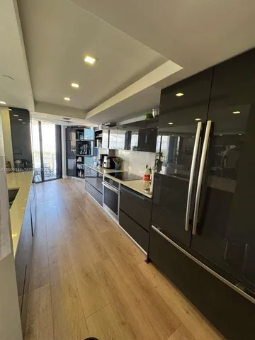 a kitchen with stainless steel appliances granite countertop a refrigerator and a stove