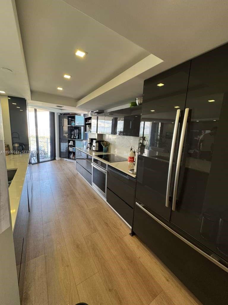 4000 Towerside Terrace, Unit 1901 Miami, FL 33138 - Photo 5 of 36 a kitchen with stainless steel appliances granite countertop a refrigerator and a stove