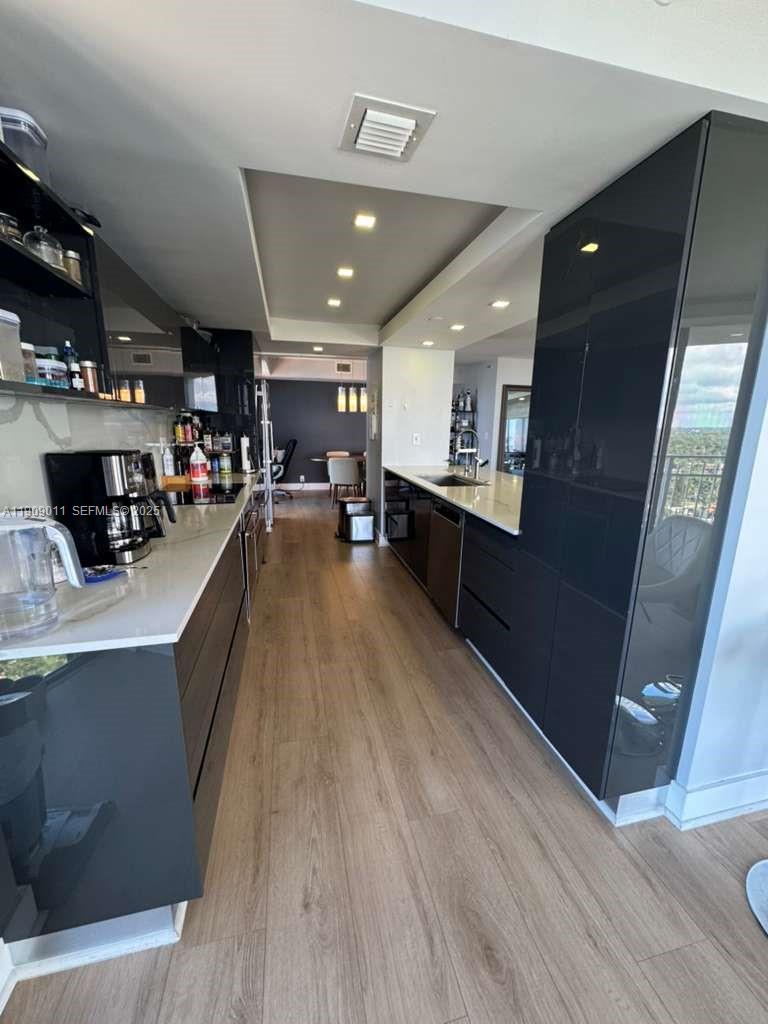 4000 Towerside Terrace, Unit 1901 Miami, FL 33138 - Photo 7 of 36 a large kitchen with stainless steel appliances lots of counter space