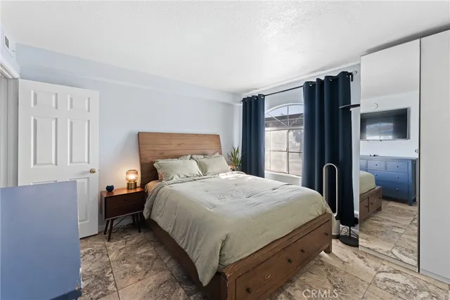 a bathroom with a toilet a sink a tub and mirror