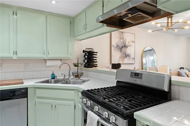 a kitchen that has a sink and a stove