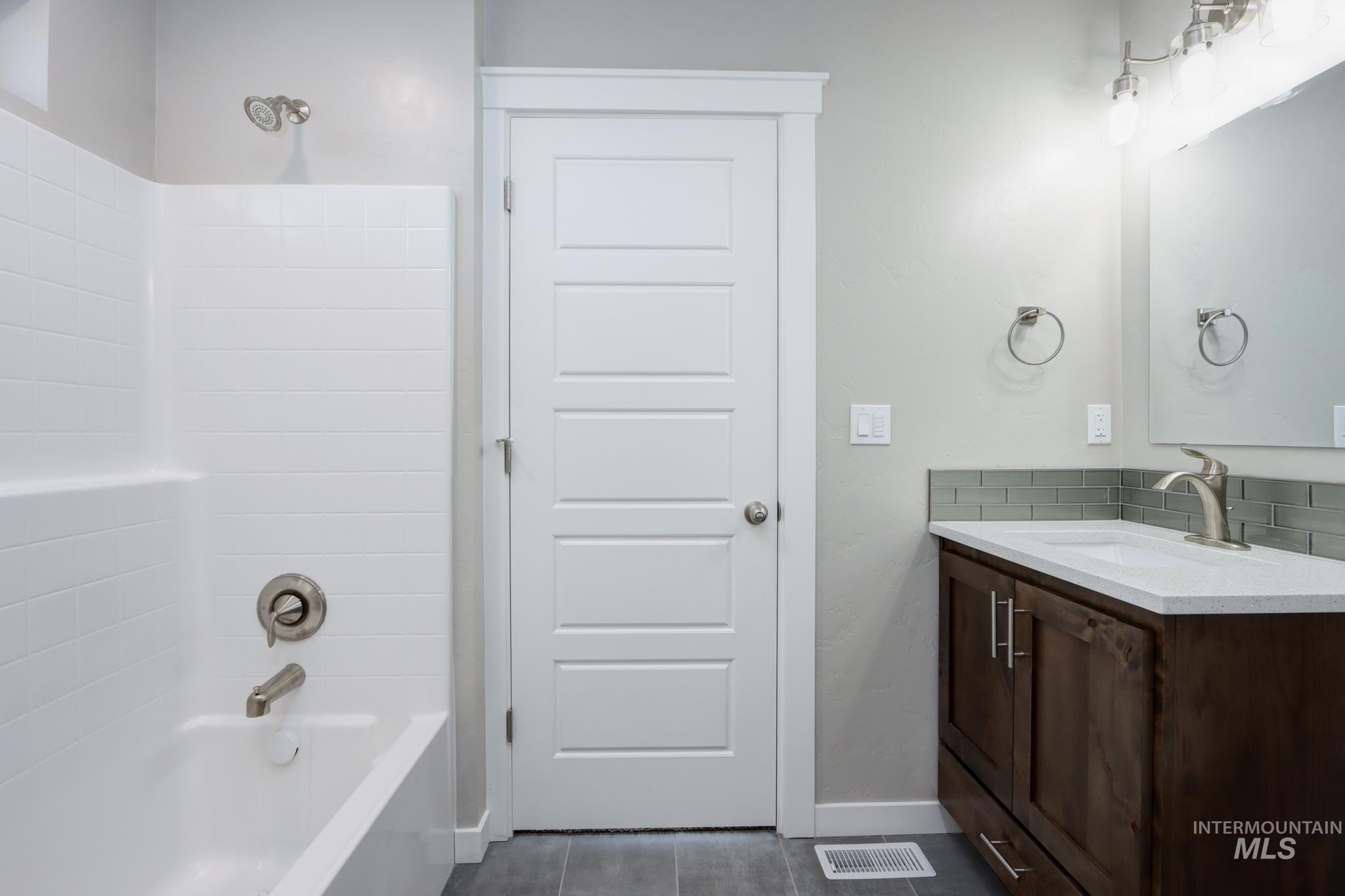 824 North 5th Street Nyssa, OR 97913 - Photo 13 of 23 Full bath with vanity, decorative backsplash, and shower / bathtub combination