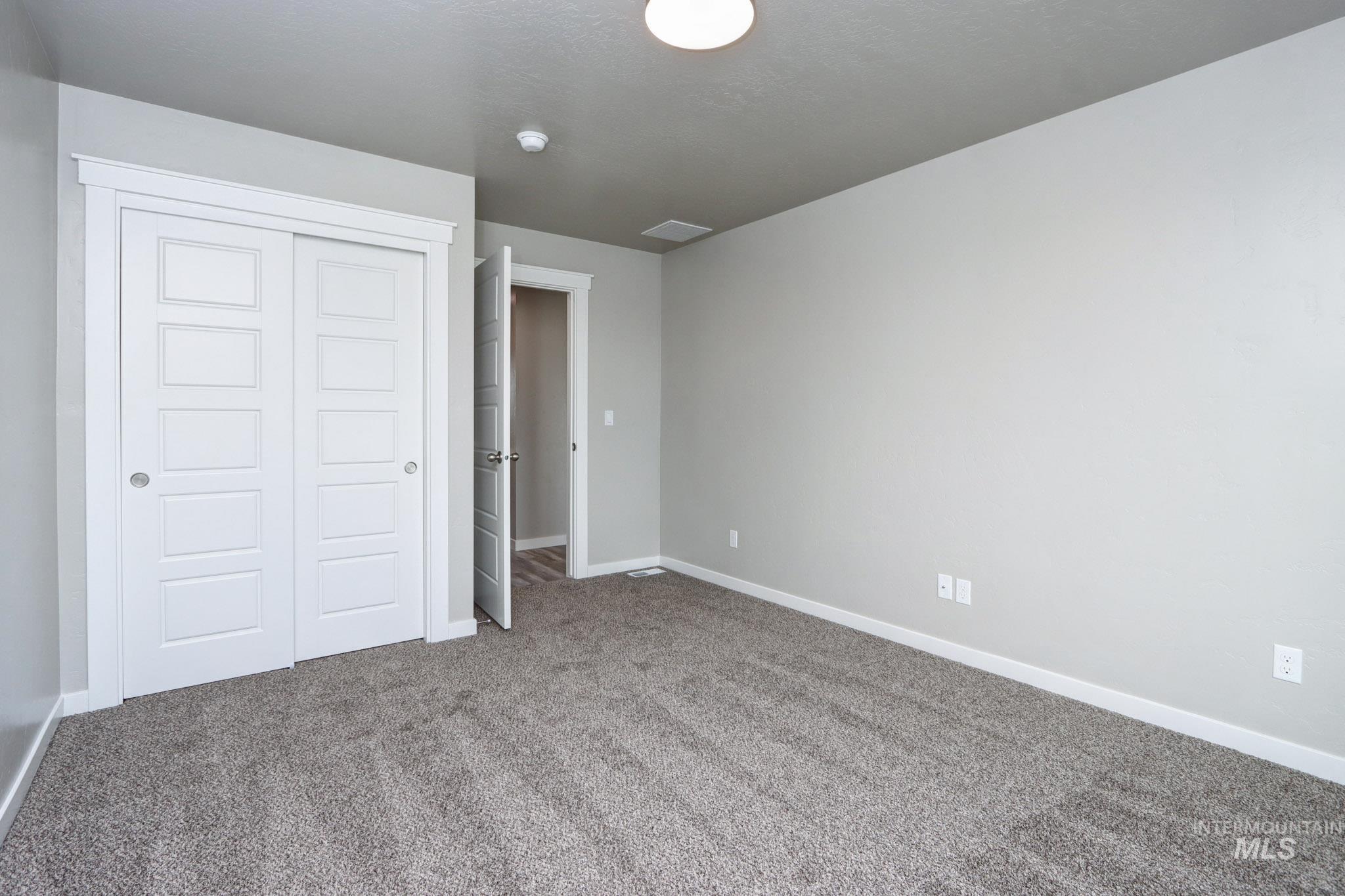 824 North 5th Street Nyssa, OR 97913 - Photo 17 of 23 Unfurnished bedroom with carpet and a closet