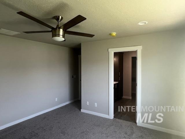 824 North 5th Street Nyssa, OR 97913 - Photo 5 of 23 Unfurnished bedroom featuring carpet floors, a textured ceiling, and ceiling fan