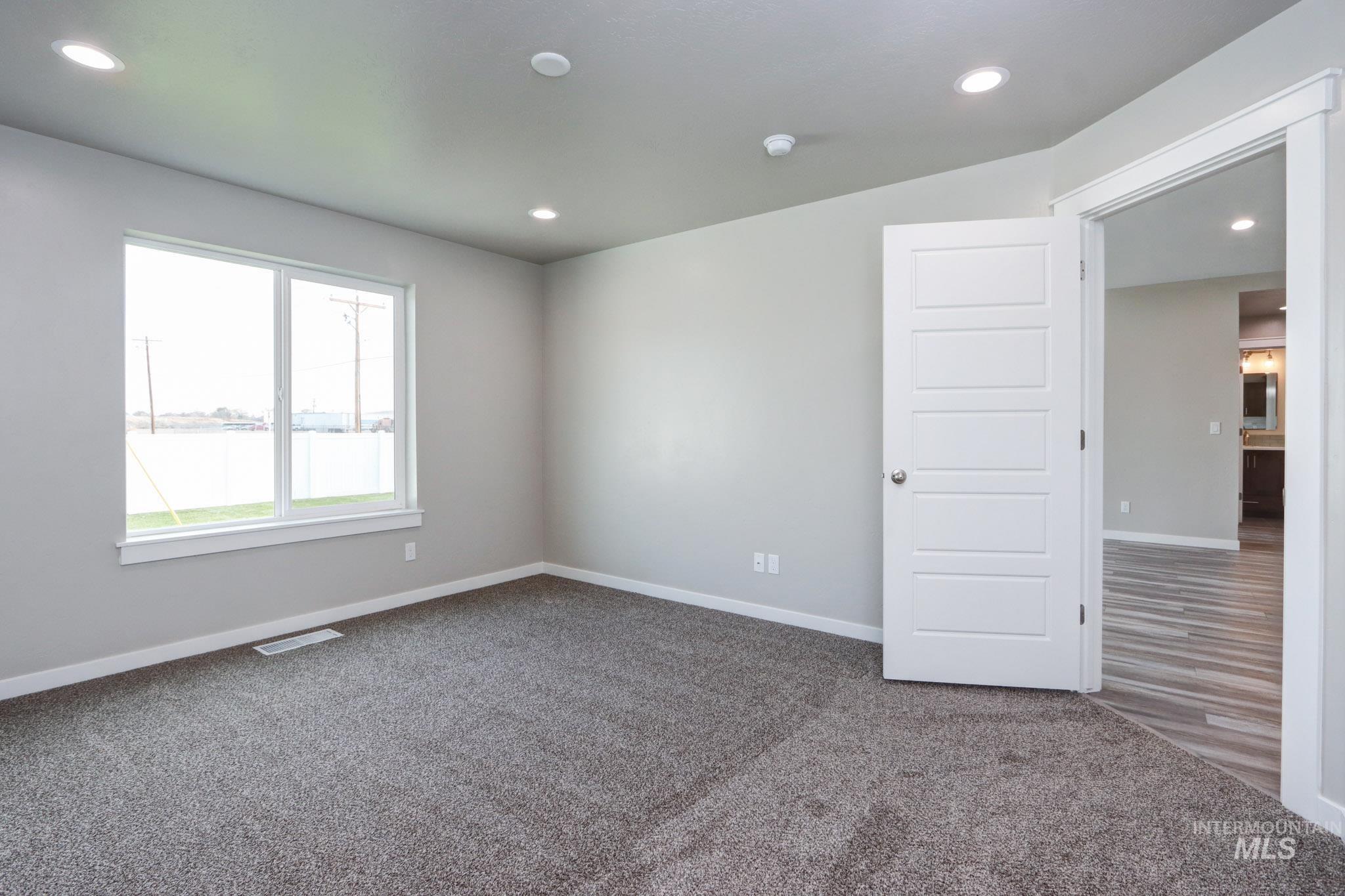 824 North 5th Street Nyssa, OR 97913 - Photo 10 of 23 Carpeted spare room featuring recessed lighting and a water view