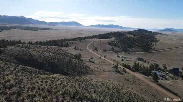 a view of a mountain with a forest