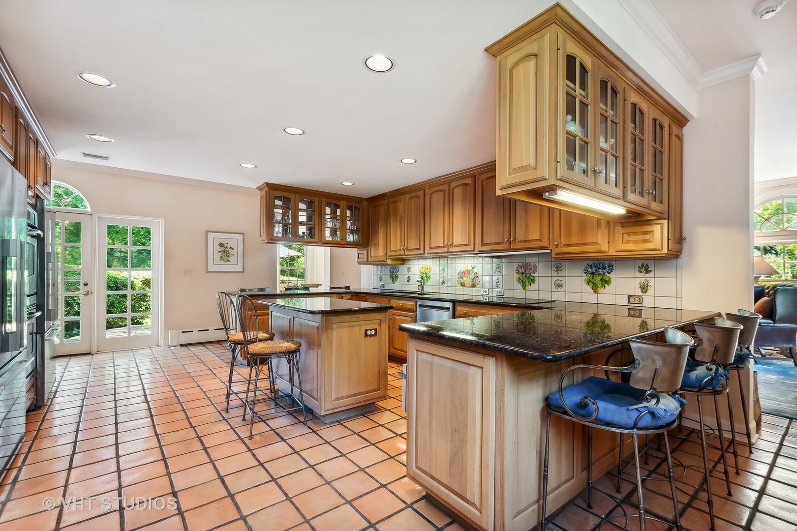 5 West County Line Road Barrington Hills, IL 60010 - Photo 19 of 77 a kitchen with stainless steel appliances granite countertop a sink a stove a dining table and chairs