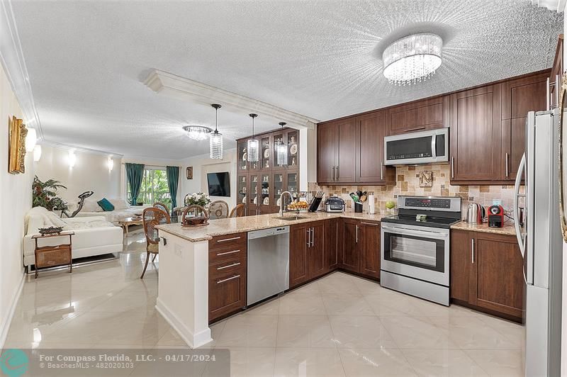 a kitchen with lots of counter top space appliances and cabinets