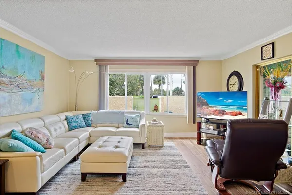 a living room with furniture a rug and a window