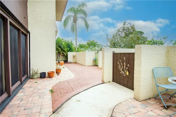 a aerial view of a house with a yard and potted plants