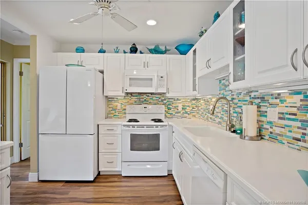 a kitchen with stainless steel appliances a refrigerator sink and cabinets