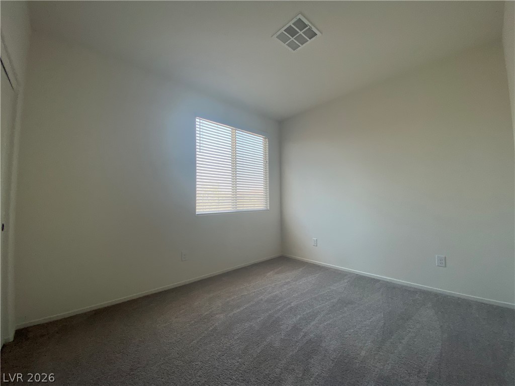 436 Cadence View Way Henderson, NV 89011 - Photo 20 of 36 An airy bedroom with soft carpeting and ample natural light through window blinds.