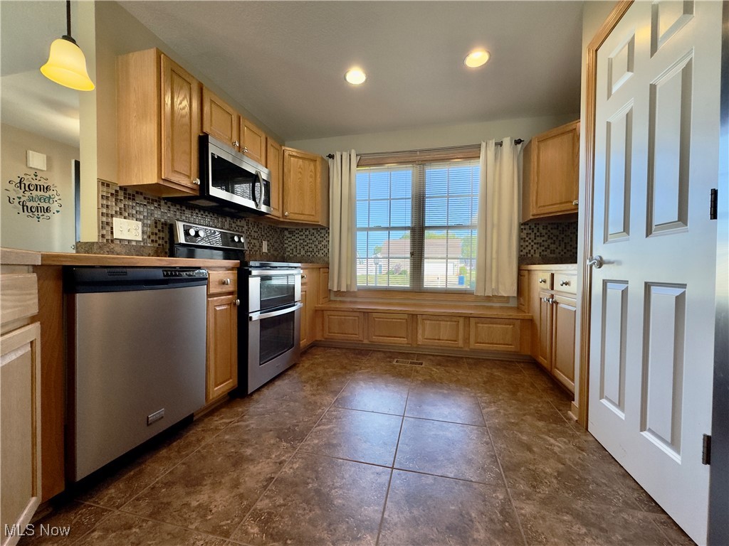 6014 Wentworth Road Southwest Canton, OH 44706 - Photo 7 of 22 Kitchen with stainless steel appliances, backsplash, hanging light fixtures, recessed lighting, and pantry