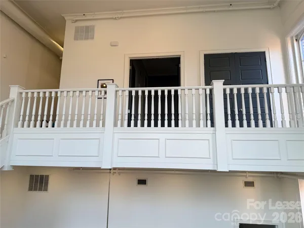 a view of a living room and entryway with a furniture