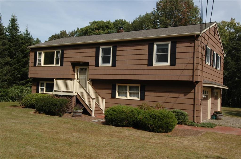 576 Benson Road Middlebury, CT 06762 - Photo 1 of 1 a front view of a house with a yard