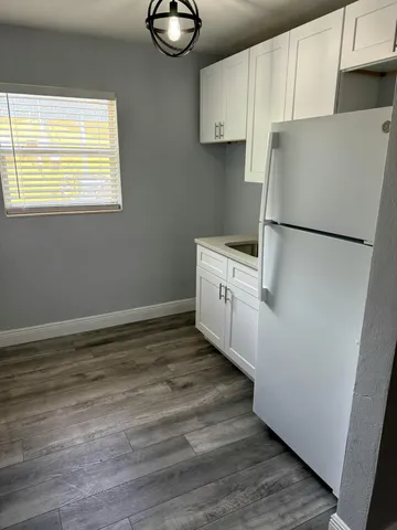 a view of a kitchen with an empty space and a window