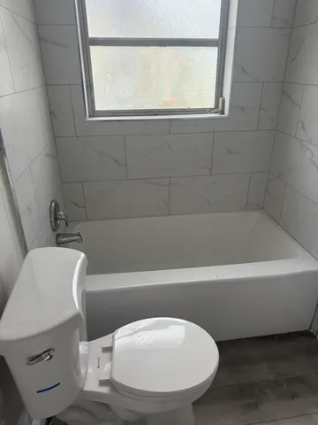 a bath tub sitting next to a white toilet
