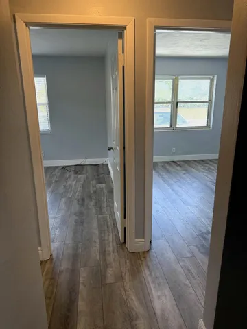 an empty room with wooden floor and closet