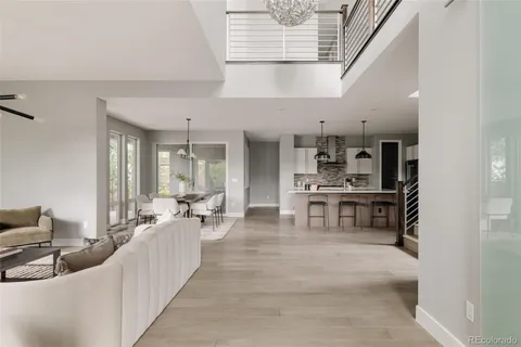 a living room with stainless steel appliances kitchen island granite countertop furniture and a view of kitchen