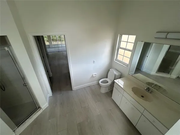 a bathroom with a sink a toilet and mirror