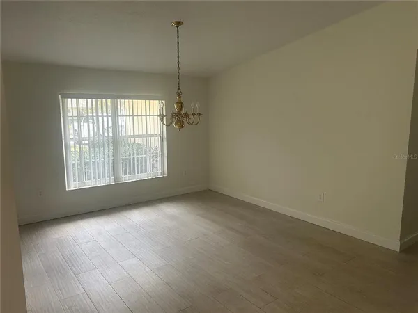 a view of an empty room with windows