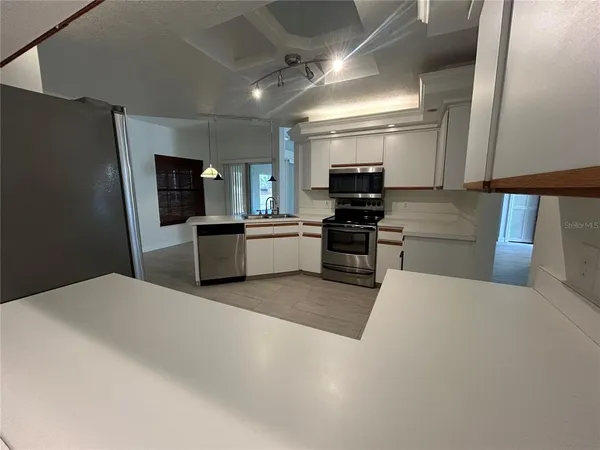 a large kitchen with cabinets and stainless steel appliances