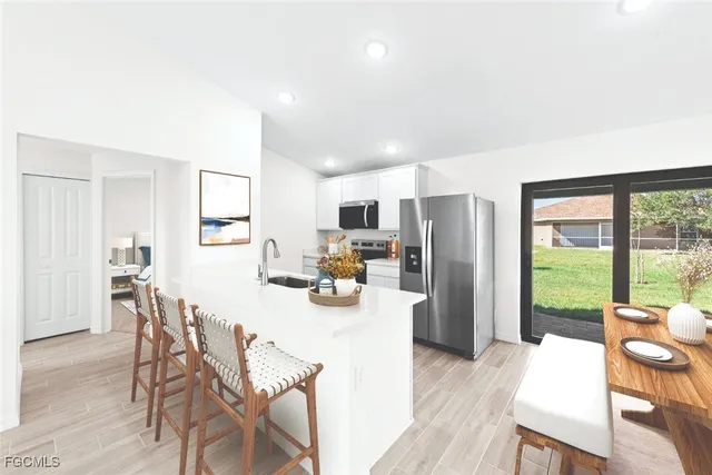 a view of a dining room with furniture large window and wooden floor