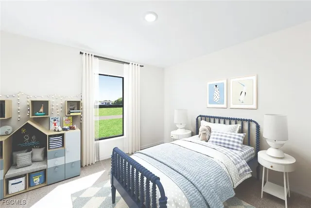 a bedroom with a bed and a lamp on dresser