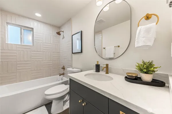 a bathroom with a sink toilet and mirror