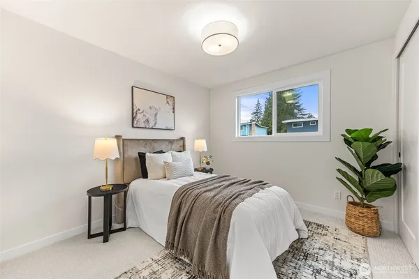 a spacious bedroom with a bed and table