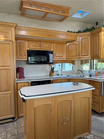 a kitchen with stainless steel appliances a sink stove and cabinets