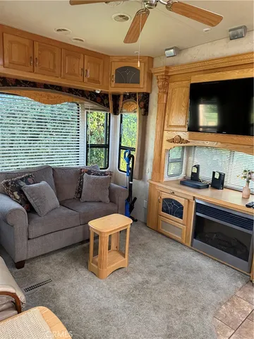 a living room with furniture a window and kitchen view