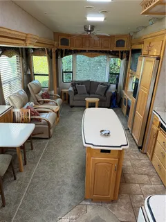 a living room with furniture a window and a flat screen tv