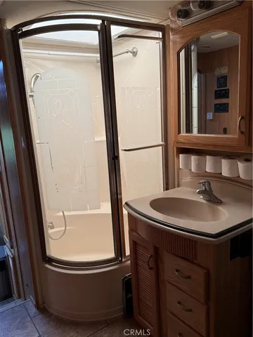 a bathroom with a sink a mirror and a bathtub
