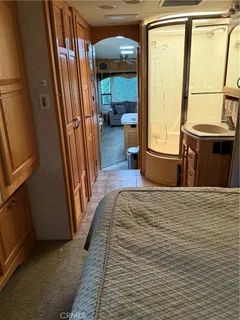 a view of a hallway with furniture and a window
