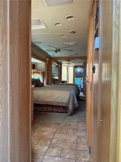 a spacious bedroom with a bed and glass door
