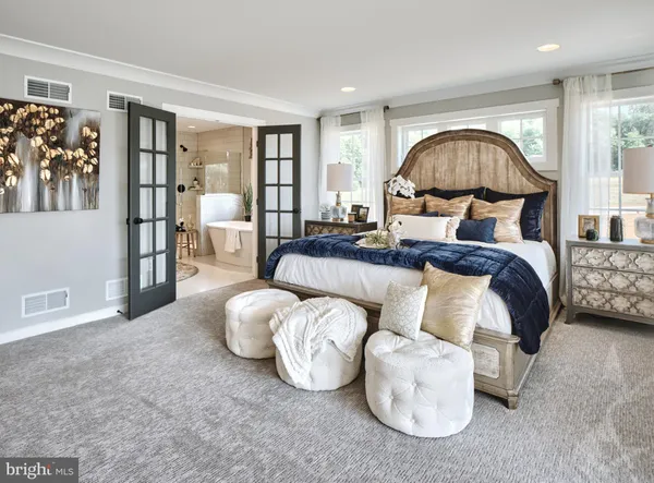 a bedroom with bed and a large window