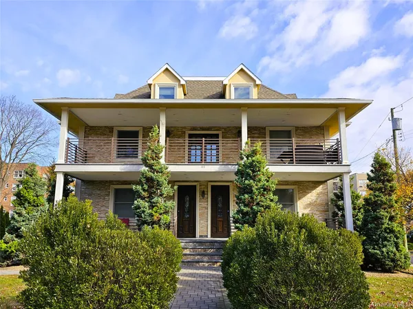 a front view of a house with garden